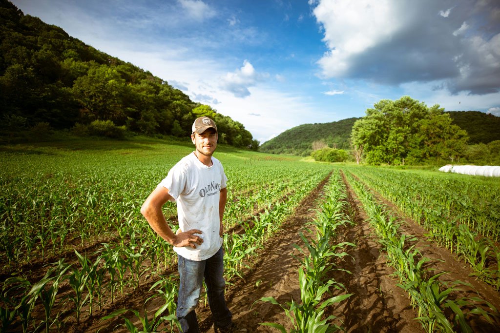 a man standing ina field of crops