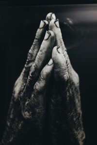 Soiled hands in prayer. God and Garden