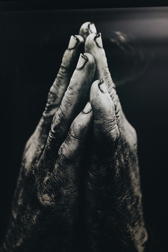 Soil covered hands in prayer. God and Garden