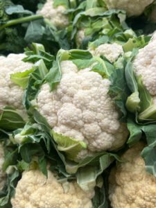 white head of cauliflower in a garden